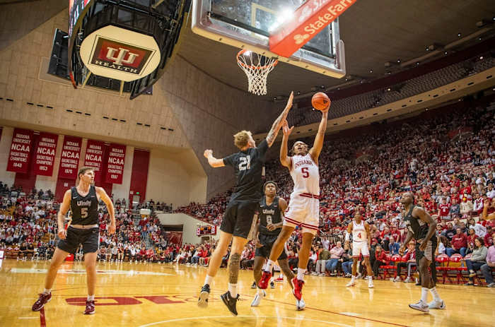 Malik Reneau (5) shoots past University of Indianapolis' Julian Steinfeld (21) during the Indiana versus University of Indianapolis men's basketball game.