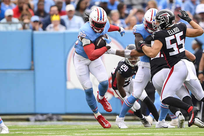 Tennessee Titans running back Derrick Henry (22) runs the ball against the Atlanta Falcons during the first half at Nissan Stadium.