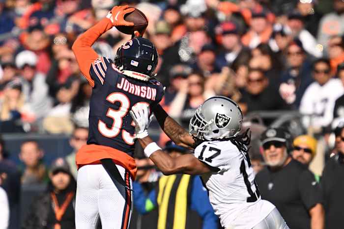 Oct 22, 2023; Chicago, Illinois, USA; Chicago Bears defensive back Jaylon Johnson (33) steps in front of Las Vegas Raiders wide receiver Davante Adams (17) to intercept a pass before returning the ball for a touchdown in the fourth quarter at Soldier Field. Mandatory Credit: Jamie Sabau-USA TODAY Sports