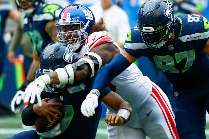 New York Giants defensive end Leonard Williams (99) beats a block by Seattle Seahawks tight end Noah Fant (87) to sack quarterback Geno Smith (7) during the second quarter at Lumen Field.