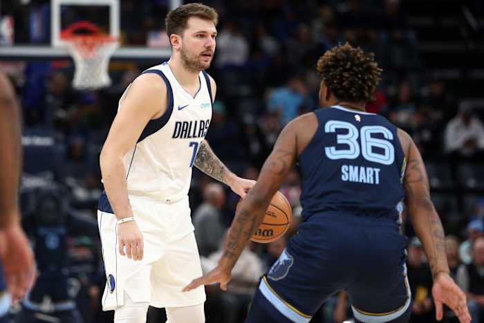 Dallas Mavericks superstar Luka Doncic being guarded by Memphis Grizzlies' Marcus Smart.