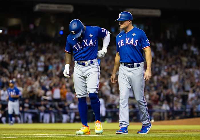 Oct 30, 2023; Phoenix, AZ, USA; Texas Rangers right fielder Adolis Garcia (left) reacts alongside first base coach Corey Ragsdale after after suffering an injury in the eighth inning of game three of the 2023 World Series against the Arizona Diamondbacks at Chase Field. Mandatory Credit: Mark J. Rebilas-USA TODAY Sports