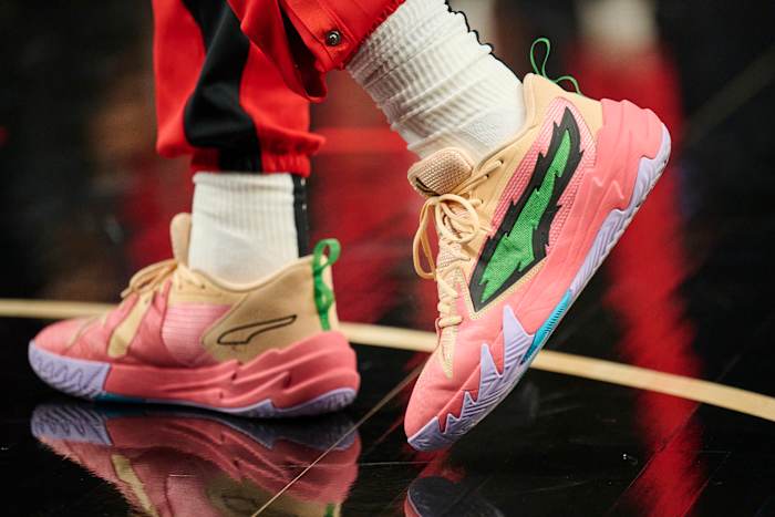 Portland Trail Blazers guard Scoot Henderson's pink and green PUMA shoes.