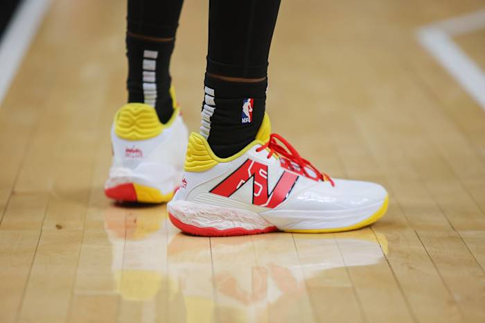 Atlanta Hawks guard Dejounte Murray's white, red, and yellow New Balance sneakers.