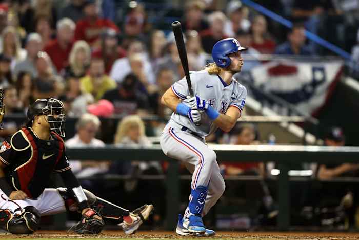 Oct 31, 2023; Phoenix, Arizona, USA; Texas Rangers left fielder Travis Jankowski (16) hits a two run double against the Arizona Diamondbacks during the third inning in game four of the 2023 World Series at Chase Field. Mandatory Credit: Mark J. Rebilas-USA TODAY Sports
