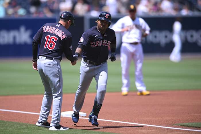 Aug 24, 2022; San Diego, California, USA; Cleveland Guardians third baseman Jose Ramirez (center) is congratulated by third base coach Mike Sarbaugh (16) after hitting a home run during the first inning against the San Diego Padres at Petco Park. Mandatory Credit: Orlando Ramirez-USA TODAY Sports