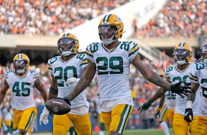 Rasul Douglas runs with his arms out, holding the ball in one hand to celebrate a fumble recovery