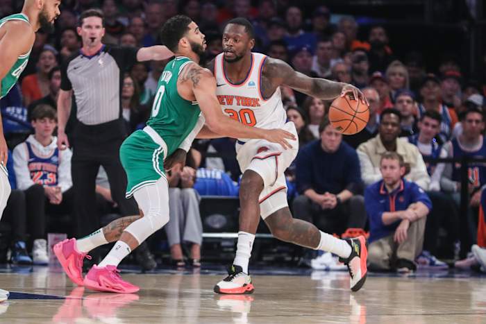 New York Knicks forward Julius Randle dribbles past Boston Celtics forward Jayson Tatum.