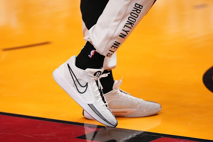 Brooklyn Nets forward Trendon Watford's white and black Nike sneakers.