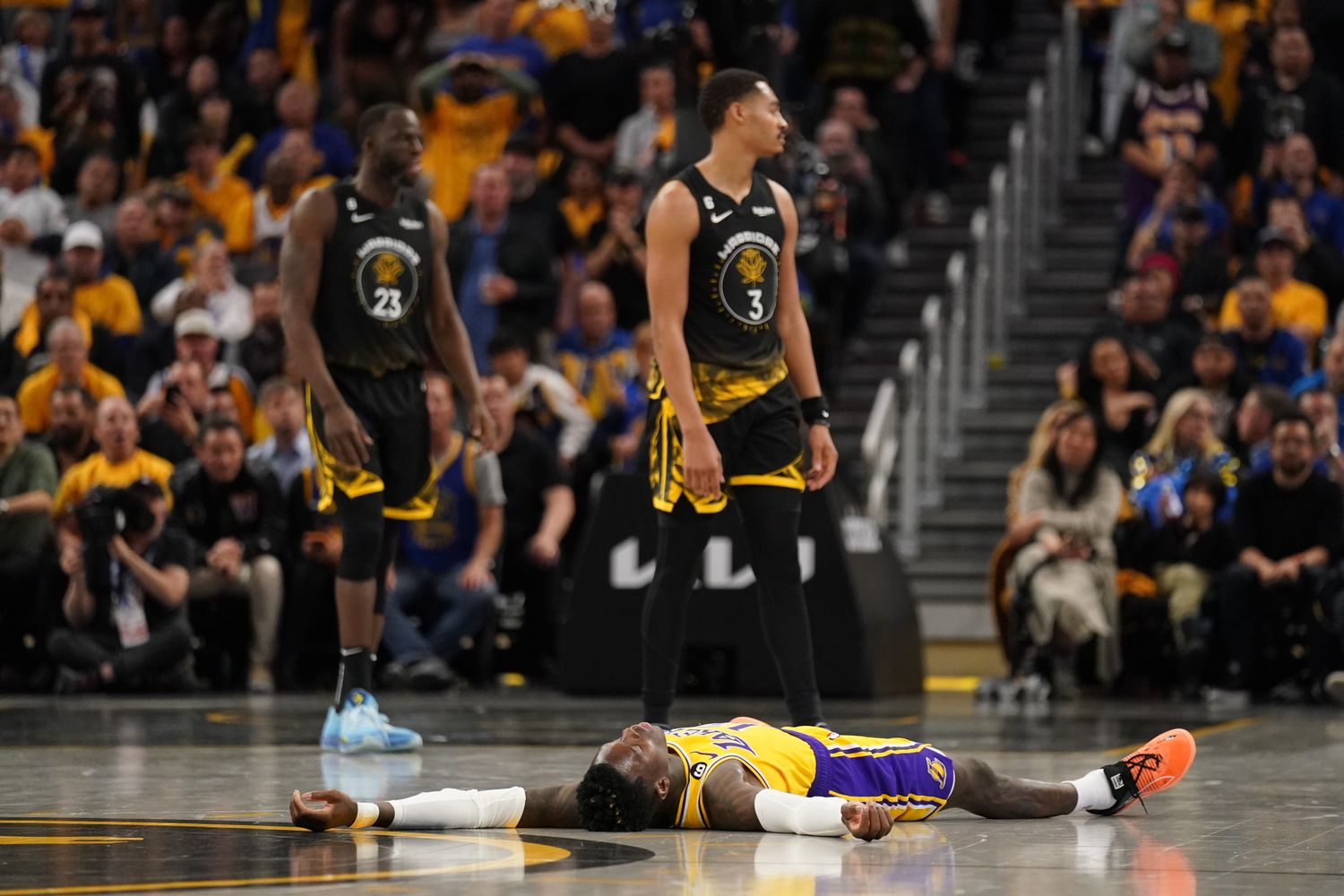 Los Angeles Lakers guard Dennis Schroder (17) lays on the ground after being fouled by Golden State Warriors guard Jordan Poole (3) in the fourth quarter during game one of the 2023 NBA playoffs at the Chase Center.