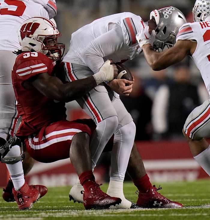 Wisconsin linebacker Maema Njongmeta (55) sacks Ohio State quarterback Kyle McCord (6) during the third quarter of their game Saturday, October 28, 2023 at Camp Randall Stadium in Madison, Wisconsin. Ohio State beat Wisconsin 24-10.