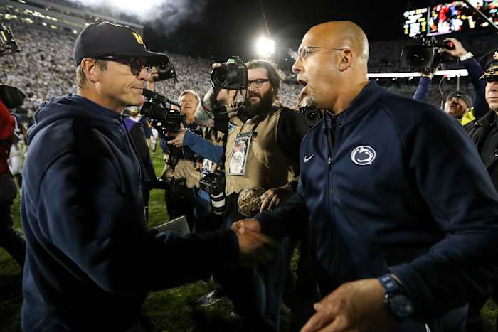 Penn State coach James Franklin greets Michigan coach Jim Harbaugh after their 2019 game at Beaver Stadium.