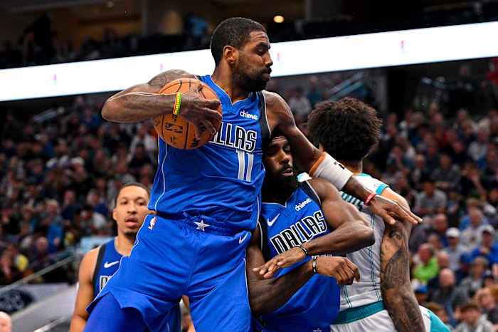 Kyrie Irving snags a rebound in the Dallas Mavericks’ win over the Charlotte Hornets on Sunday.