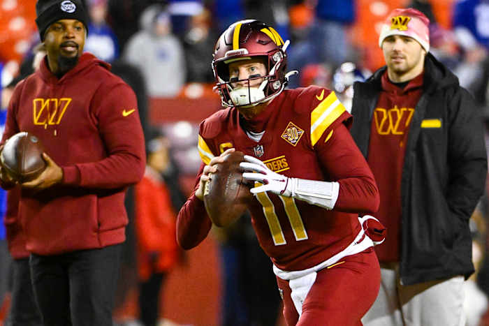 Washington Commanders quarterback Carson Wentz (11) warms up before the game against the New York Giants at FedExField.