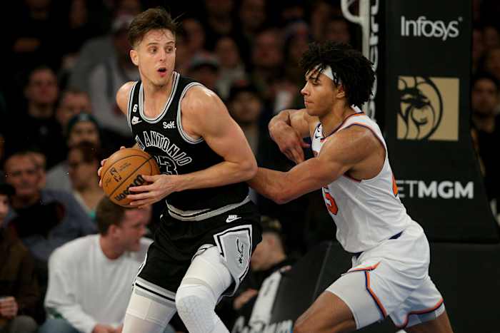Jan 4, 2023; New York, New York, USA; San Antonio Spurs forward Zach Collins (23) controls the ball against New York Knicks center Jericho Sims (45) during the fourth quarter at Madison Square Garden.