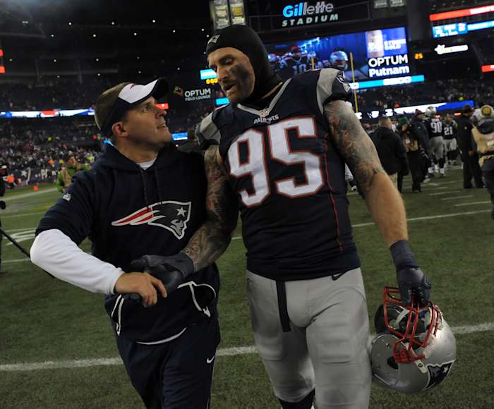 Dec 12, 2016; Foxborough, MA, USA; New England Patriots offensive coordinator Josh McDaniels congratulates defensive end Chris Long (95) after defeating the Baltimore Ravens at Gillette Stadium.