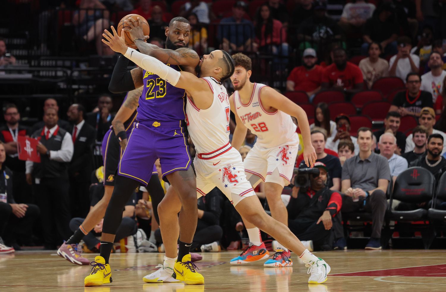 Lakers forward LeBron James (23) defends the ball from Houston Rockets forward Dillon Brooks (9) in the first quarter at Toyota Center.