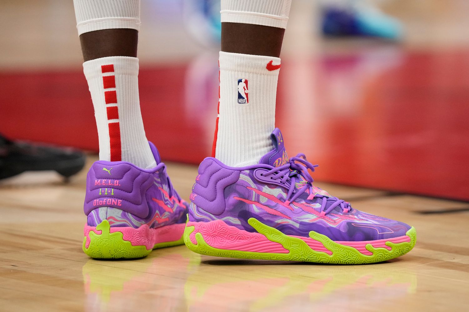 LaMelo Ball's purple and green PUMA sneakers.