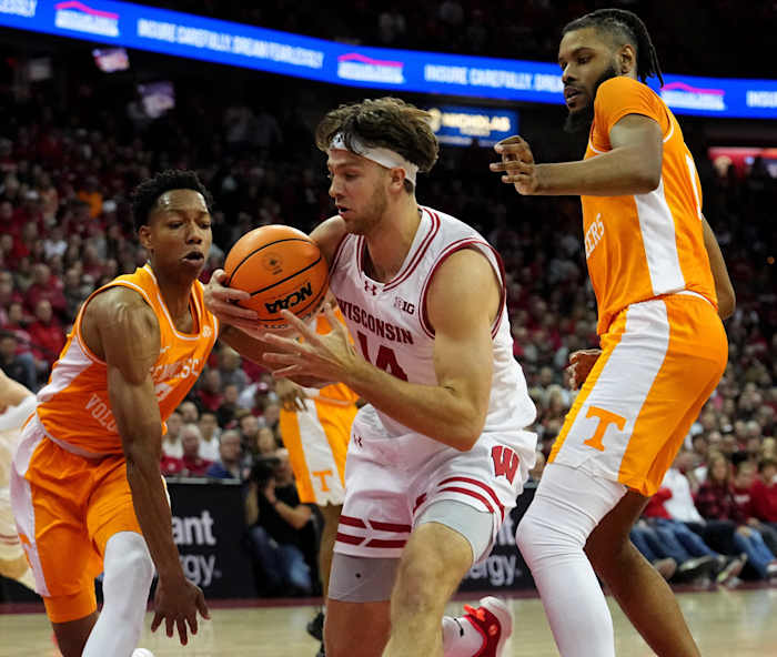 Wisconsin forward Carter Gilmore (14) is double-teamed by Tennessee guard Jordan Gainey (2) and forward Jonas Aidoo (0) during the second half of their game Friday, November 10, 2023 at the Kohl Center in Madison, Wisconsin. Tennessee beat Wisconsin 80-70.