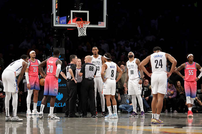 Referees huddle to discuss a foul by Washington Wizards forward Deni Avdija (9) and a goaltending by Wizards center Daniel Gafford (21) against Brooklyn Nets guard Cam Thomas (24) during the fourth quarter at Barclays Center.