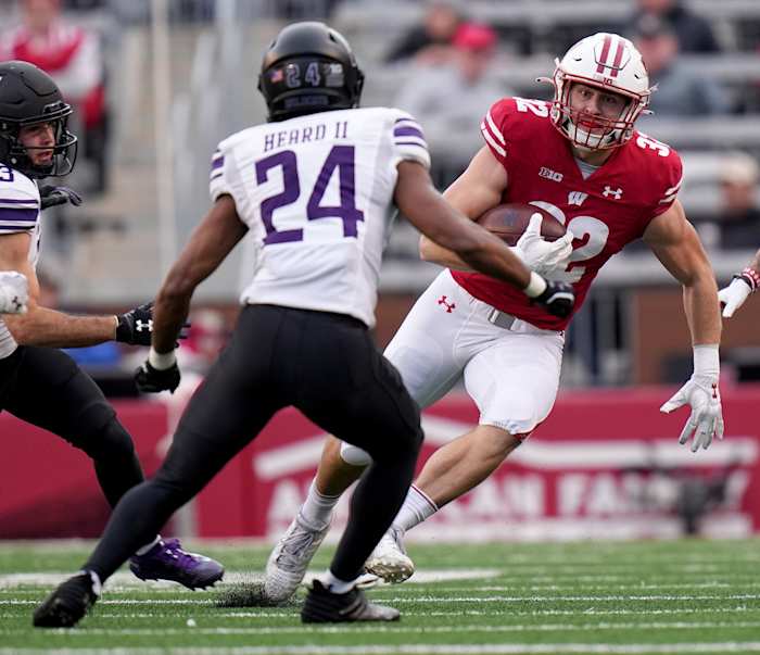 Nov 11, 2023; Madison, Wisconsin, USA; Wisconsin Badgers linebacker Marty Strey (32) returns a kickoff against the Northwestern Wildcats during the second quarter at Camp Randall Stadium. Mandatory Credit: Mark Hoffman-USA TODAY Sports