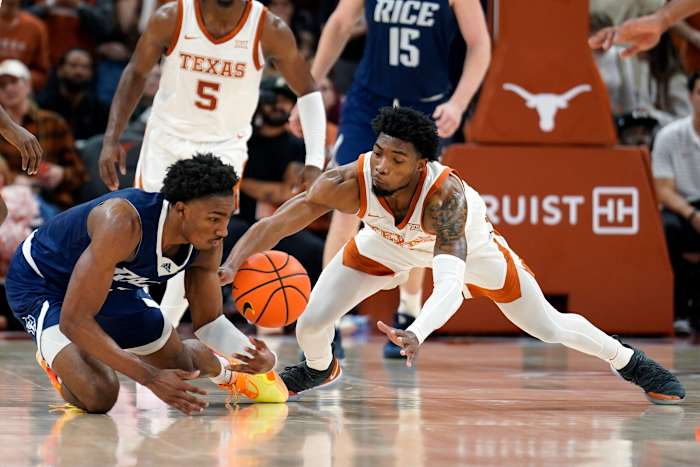 Texas Longhorns guard Tyrese Hunter (4) and Rice Owls guard Mekhi Mason (2) battle for the ball during the first half at Moody Center.