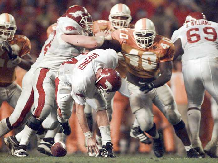 Razorbacks quarterback Clint Stoerner loses the ball on a fumble against Tennessee in 1998 as Brandon Burlsworth blocks