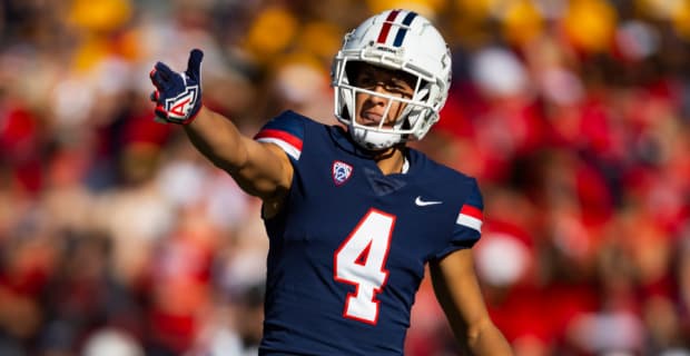 Arizona Wildcats wide receiver Tetairoa McMillan celebrates catching a pass during a college football game.