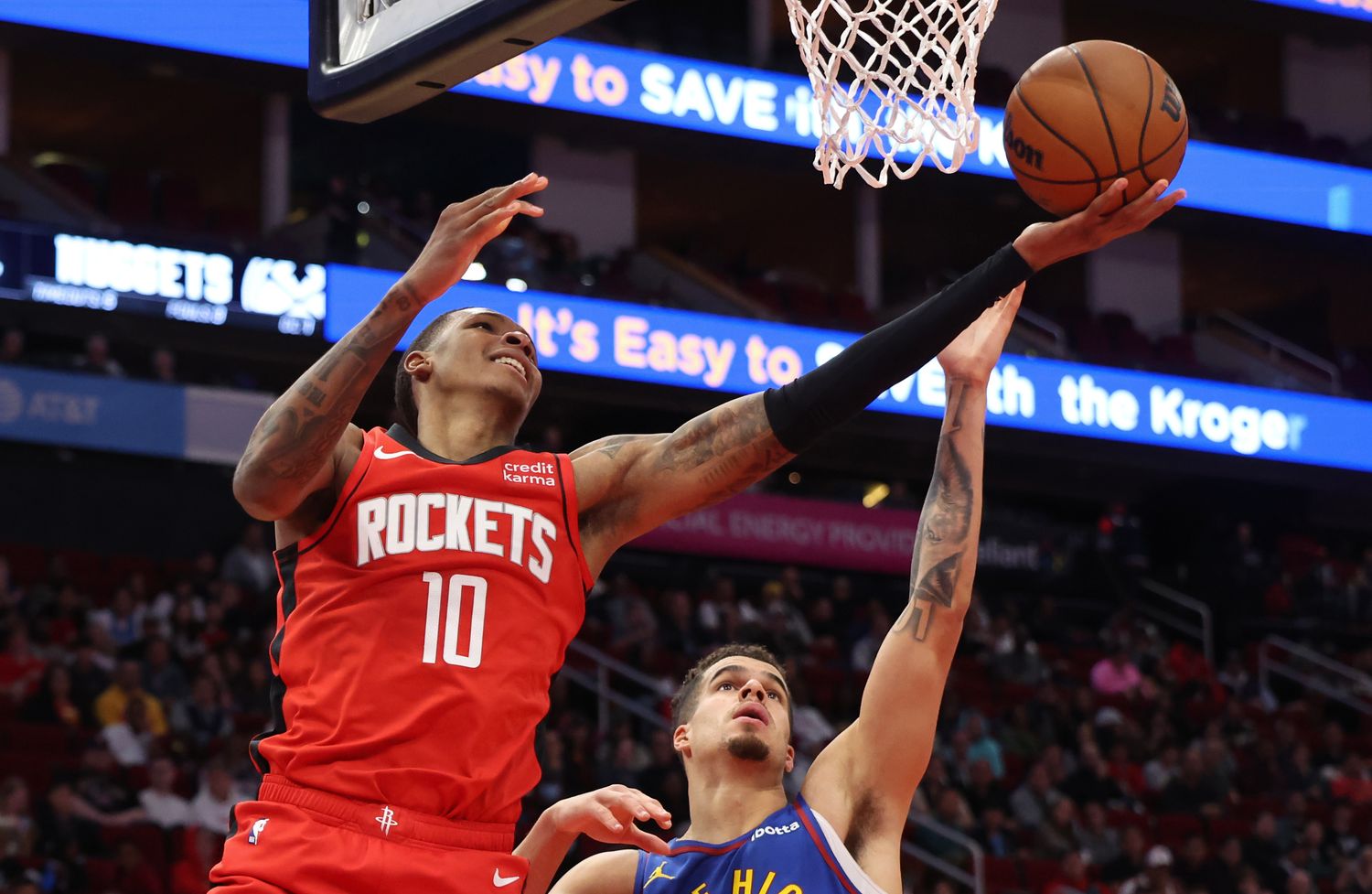 Rockets forward Jabari Smith Jr. (10) scores against Denver Nuggets forward Michael Porter Jr. (1) in the second quarter at Toyota Center.