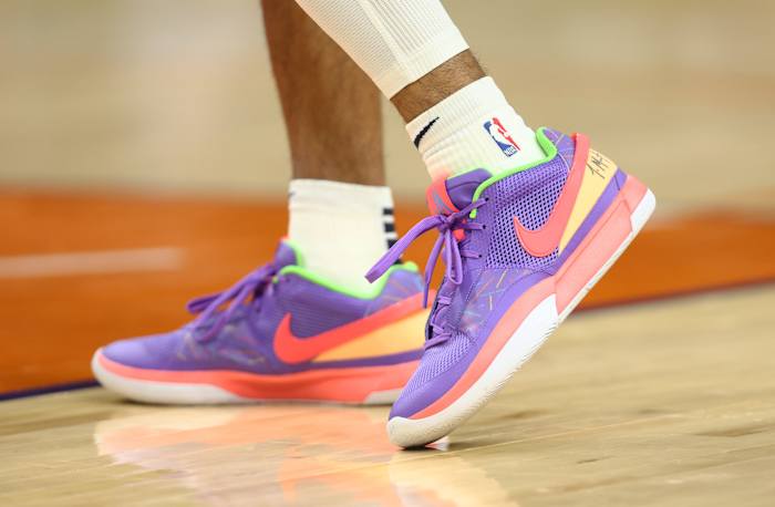 Memphis Grizzlies guard Ja Morant's purple and orange Nike sneakers.