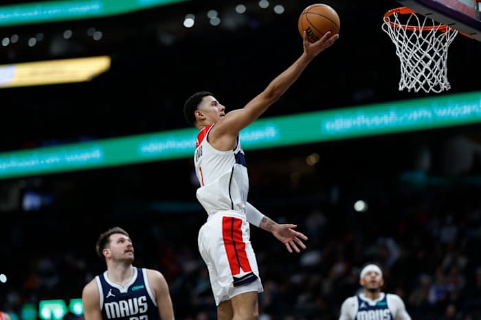 Washington Wizards guard Johnny Davis (1) shoots the ball as Dallas Mavericks guard Luka Doncic (77) looks on in the fourth quarter at Capital One Arena.