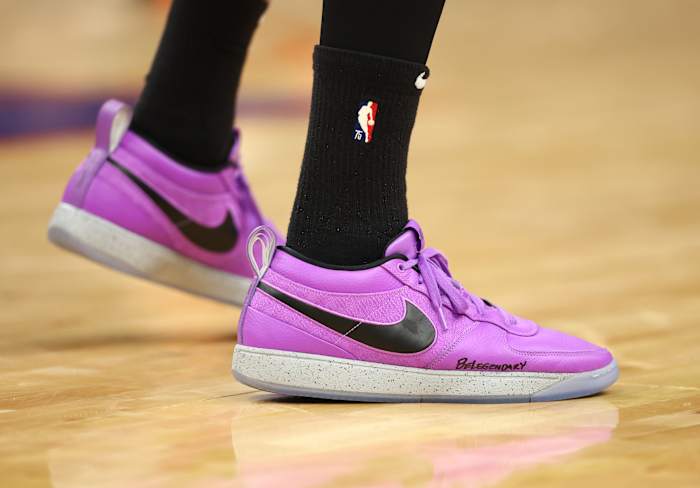 Phoenix Suns guard Devin Booker's purple and black Nike sneakers.