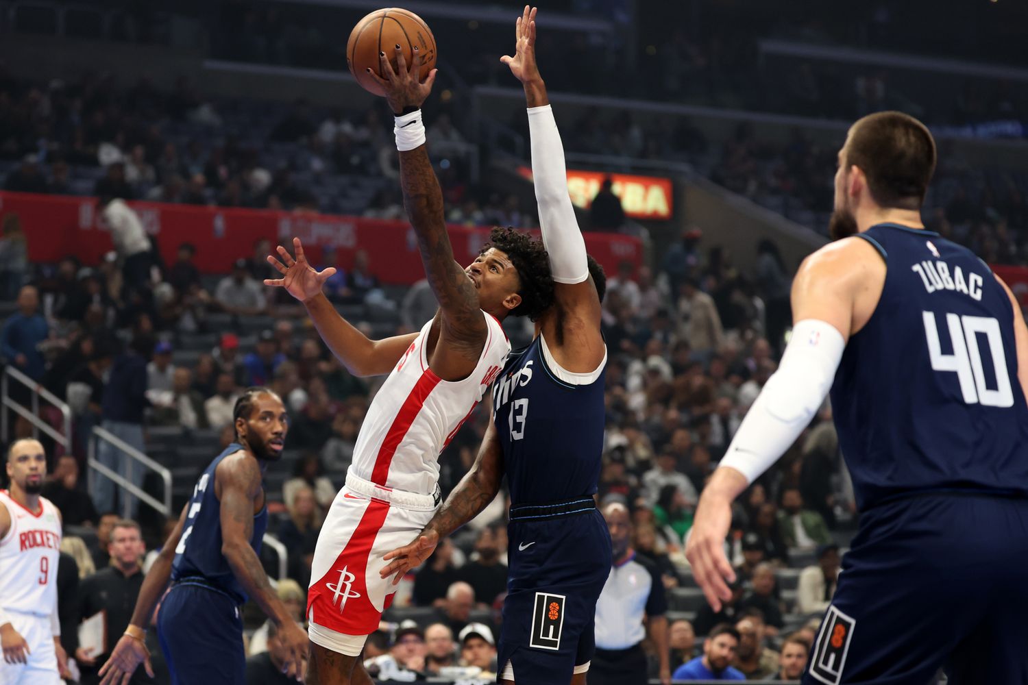 Houston Rockets guard Jalen Green shoots the ball past L.A. Clippers forward Paul George during the first quarter at Crypto.com Arena.