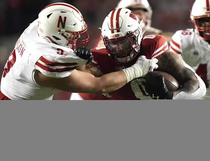Nebraska's Ty Robinson takes down Wisconsin's Braelon Allen for a 5-yard loss during the fourth quarter on Nov. 18, 2023.