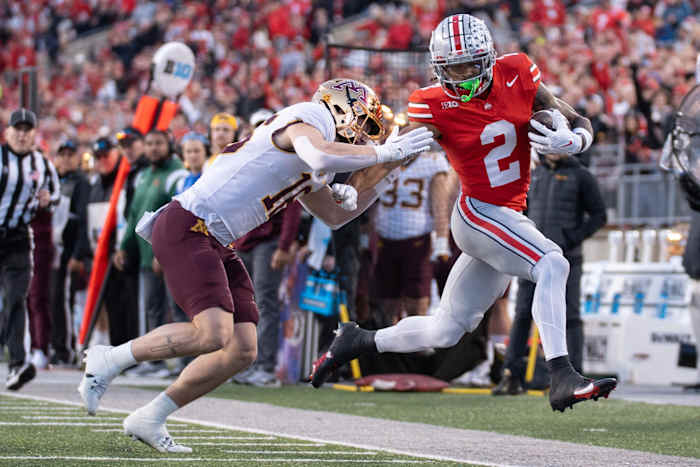 Nov 18, 2023; Columbus, Ohio, USA; Ohio State Buckeyes wide receiver Emeka Egbuka (2) is run out of bounds by Minnesota Golden Gophers defensive back Coleman Bryson (16) during the first half of their game on Saturday, Nov. 18, 2023 at Ohio Stadium.
