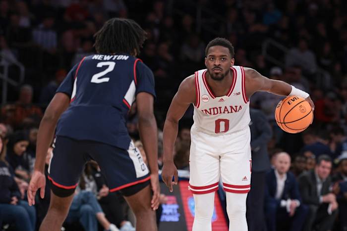 Indiana Hoosiers guard Xavier Johnson (0) dribbles in front of Connecticut Huskies guard Tristen Newton (2) during the second half at Madison Square Garden