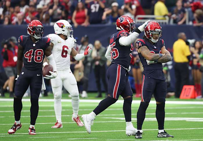 Texans cornerback Derek Stingley Jr. is congratulated with a tap on the helmet by defensive end Jerry Hughes after breaking up a pass intended for Arizona Cardinals running back James Conner