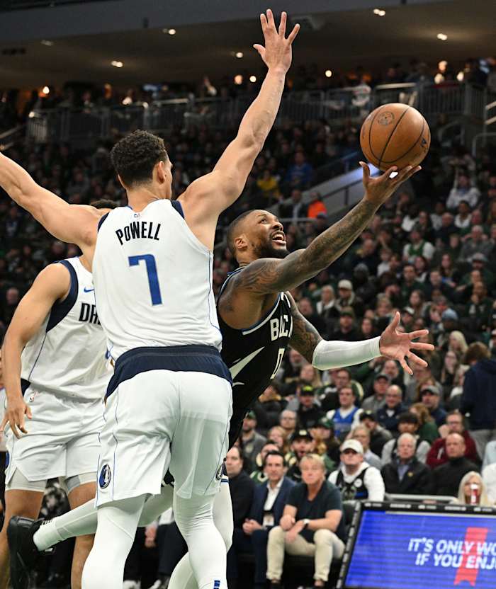 Milwaukee Bucks guard Damian Lillard (0) puts up a shot against Dallas Mavericks center Dwight Powell (7)