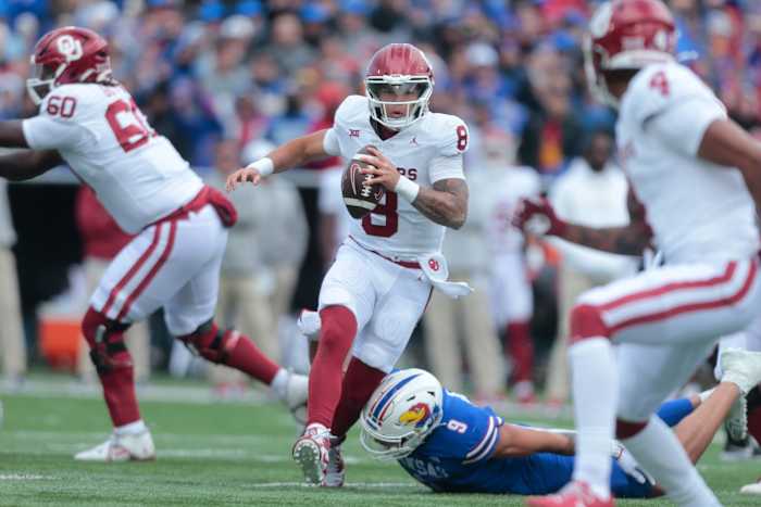 Oklahoma redshirt senior quarterback Dillon Gabriel (8) runs the ball during the first quarter of Saturday's game against Kansas inside David Booth Kansas Memorial Stadium.