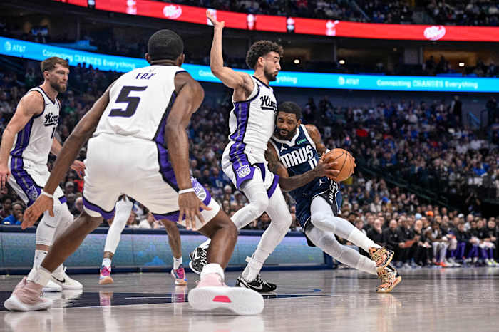 Dallas Mavericks star Kyrie Irving gets smothered by the Sacramento Kings' defense in Sunday's loss.