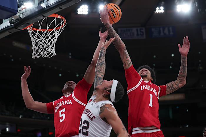 Louisville Cardinals guard Tre White (22) rebounds against Indiana Hoosiers forward Malik Reneau (5) and center Kel'el Ware (1) during the first half at Madison Square Garden.