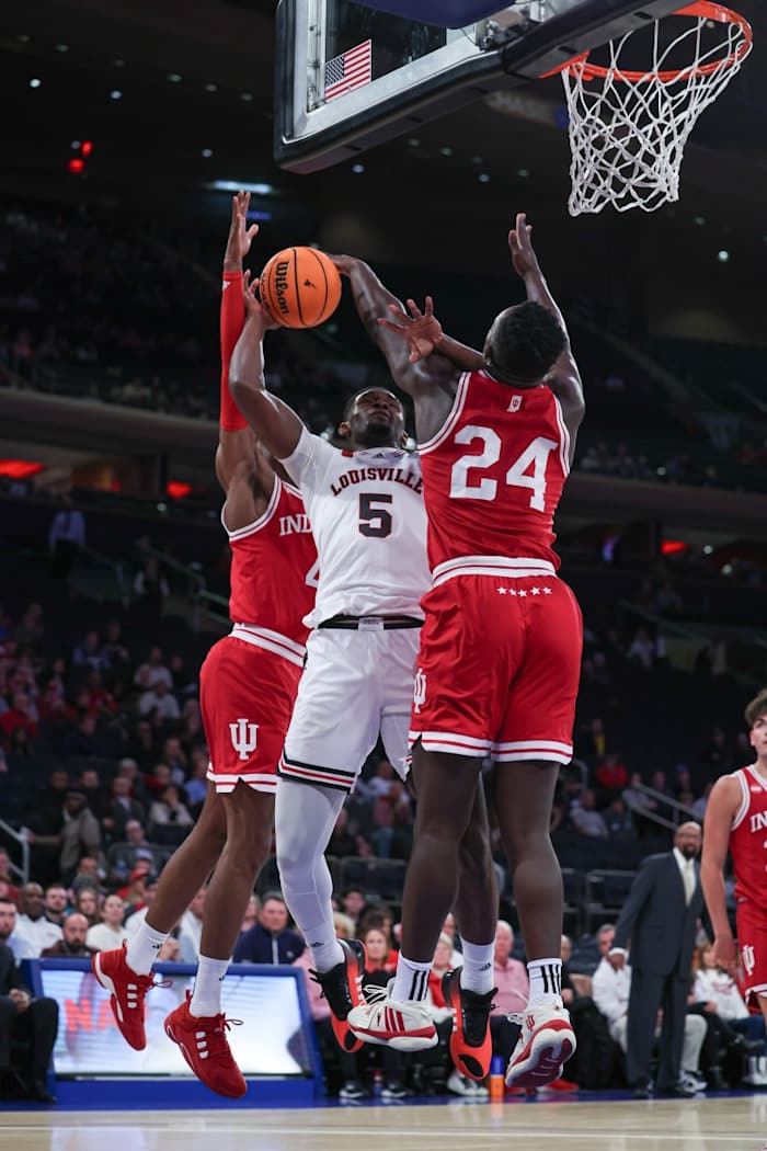 Indiana Hoosiers forward Payton Sparks (24) blocks a shot by Louisville Cardinals forward Brandon Huntley-Hatfield (5) during the first half in front of forward Anthony Walker (4) at Madison Square Garden.