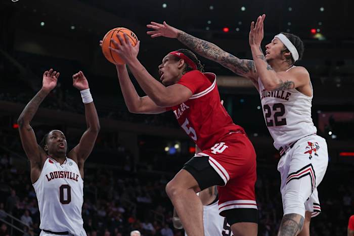 Indiana Hoosiers forward Malik Reneau (5) drives to the basket as Louisville Cardinals guard Tre White (22) and guard Mike James (0) defend during the second half at Madison Square Garden.