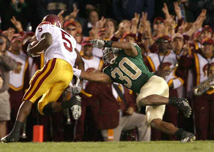 Oct. 15, 2005; South Bend, IN, USA; Southern California Trojans running back Reggie Bush avoids the tackle of Notre Dame Fighting Irish Mike Richardson on his way to a touchdown in the fourth quarter of USC's 34-31 win over Notre Dame Saturday Oct. 15 at Notre Dame Stadium. Mandatory Credit: Photo By Matt Cashore-USA TODAY Sports Copyright (c) 2005 Matt Cashore