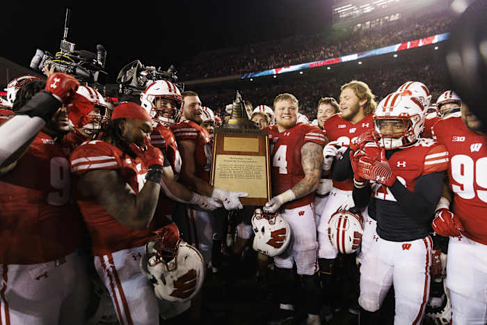 Nov 18, 2023; Madison, Wisconsin, USA; The Wisconsin Badgers celebrate with the Freedom Trophy following the game against the Nebraska Cornhuskers at Camp Randall Stadium. Mandatory Credit: Jeff Hanisch-USA TODAY Sports