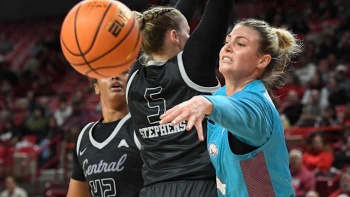 Razorbacks' Saylor Poffenbarger throws a pass on a drive as UCA's Bree Stephens guards