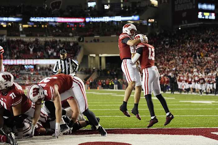 Dec 27, 2022; Phoenix, Arizona, USA; Wisconsin Badgers running back Braelon Allen (0) is hoisted by teammates as he celebrates a touchdown against the Oklahoma State Cowboys in the second half of the 2022 Guaranteed Rate Bowl at Chase Field. Mandatory Credit: Mark J. Rebilas-USA TODAY Sports