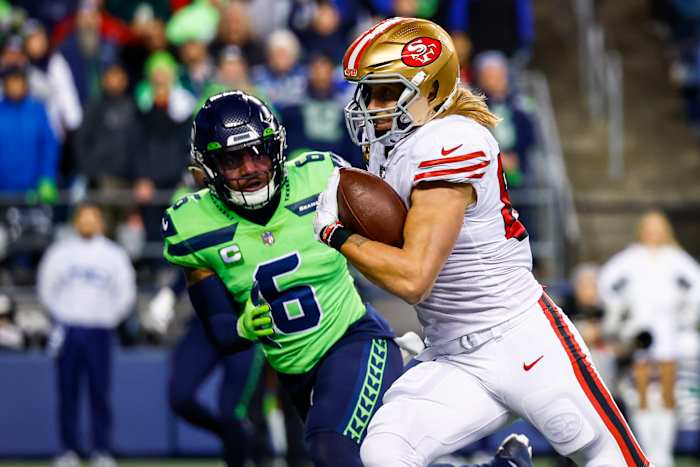 San Francisco 49ers tight end George Kittle (85) runs for a touchdown against Seattle Seahawks safety Quandre Diggs (6) after making a reception during the first quarter at Lumen Field.