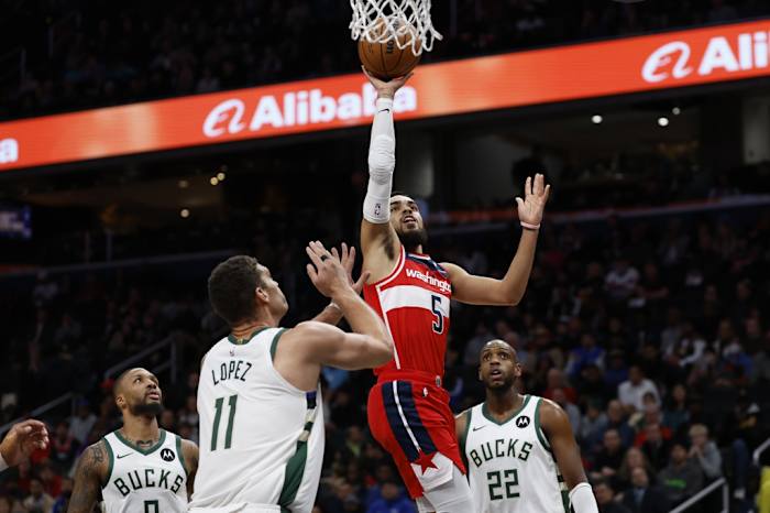 Washington Wizards guard Tyus Jones (5) shoots the ball over Milwaukee Bucks center Brook Lopez (11) in the first quarter at Capital One Arena.