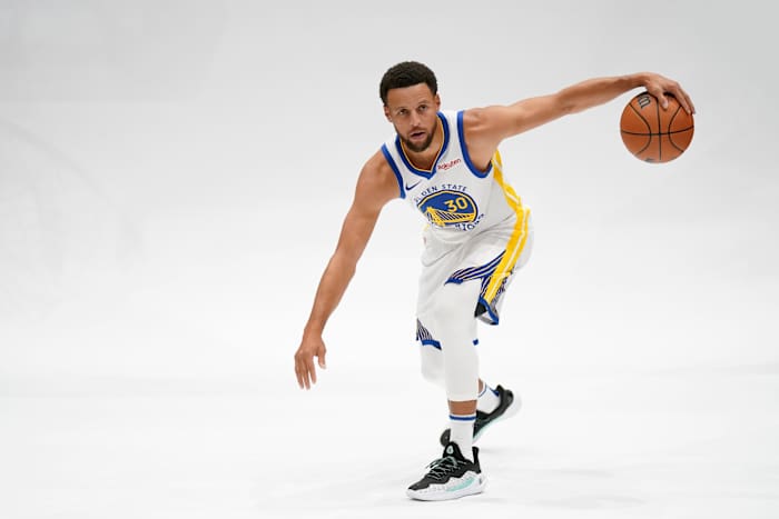 Golden State Warriors guard Stephen Curry dribbles the ball during a photo shoot.